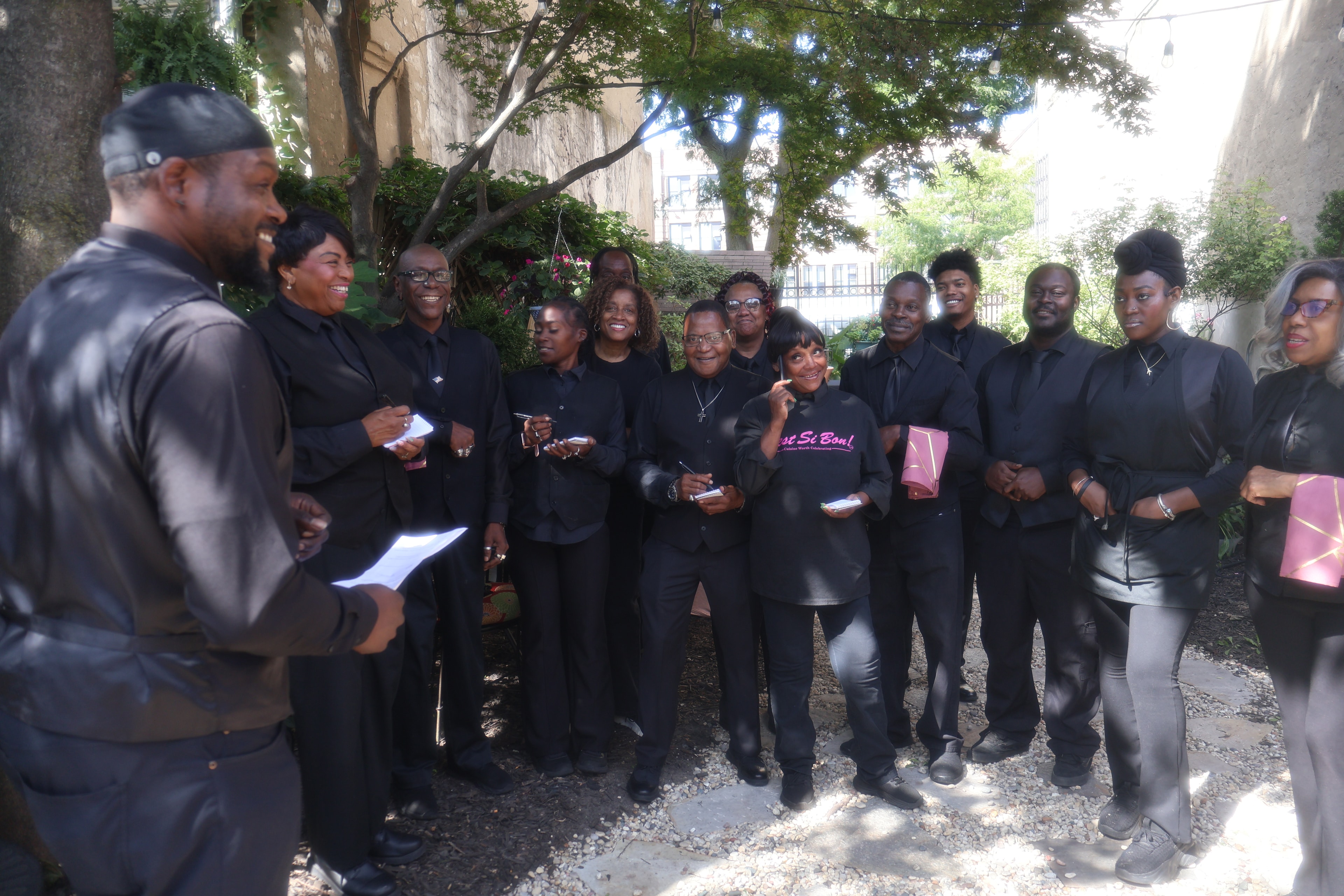 C'est Si Bon team gathered outdoors at an event