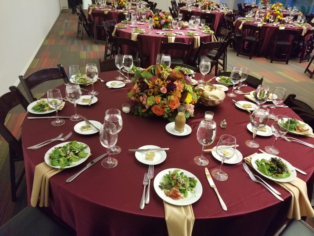 Elegantly set banquet hall with burgundy linens